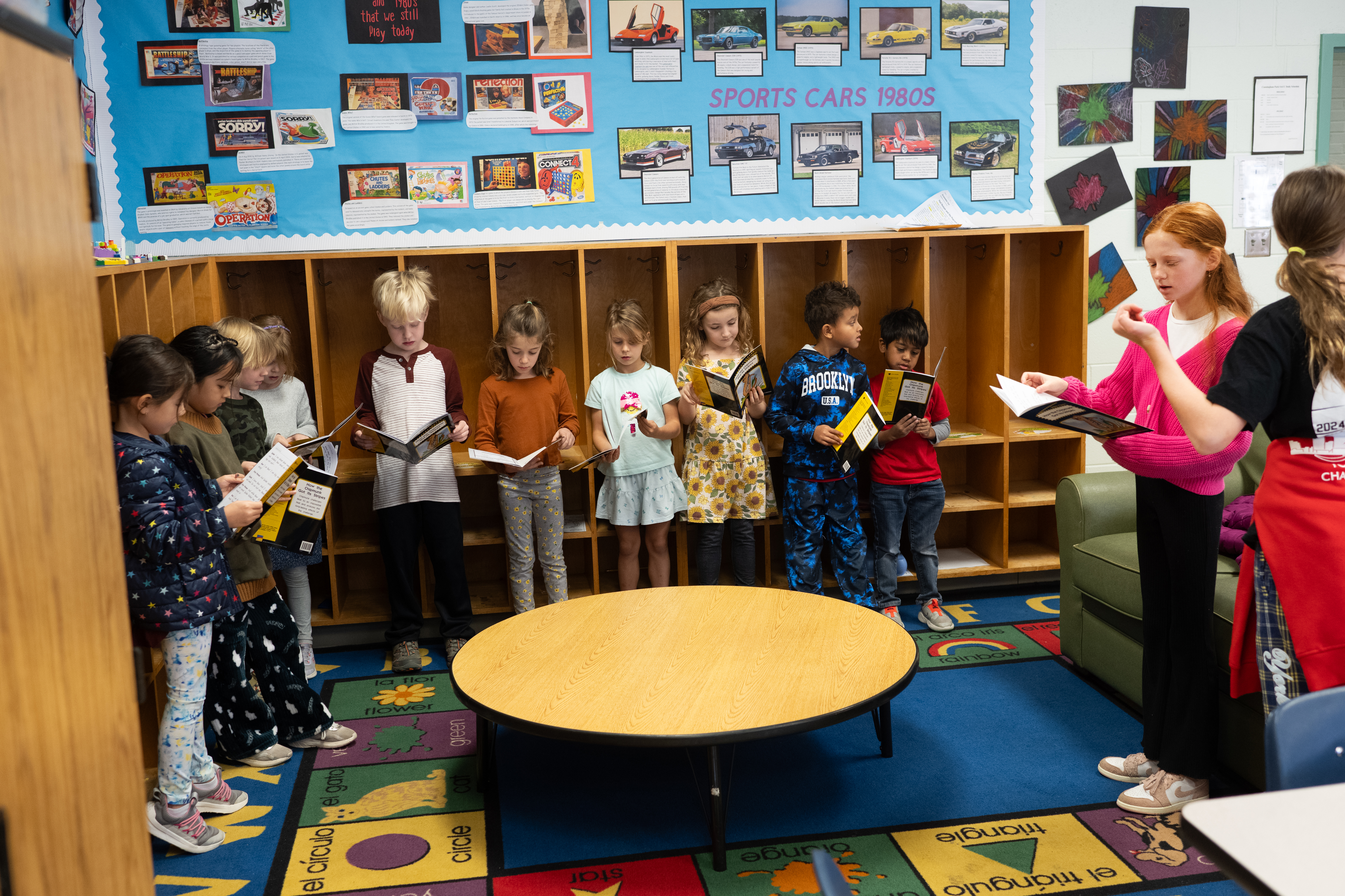 Sixth grade students at Cunningham Park Elementary School lead first grade students in a readers' theatre activity.