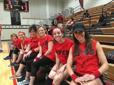 a photo of students and faculty at the basketball game